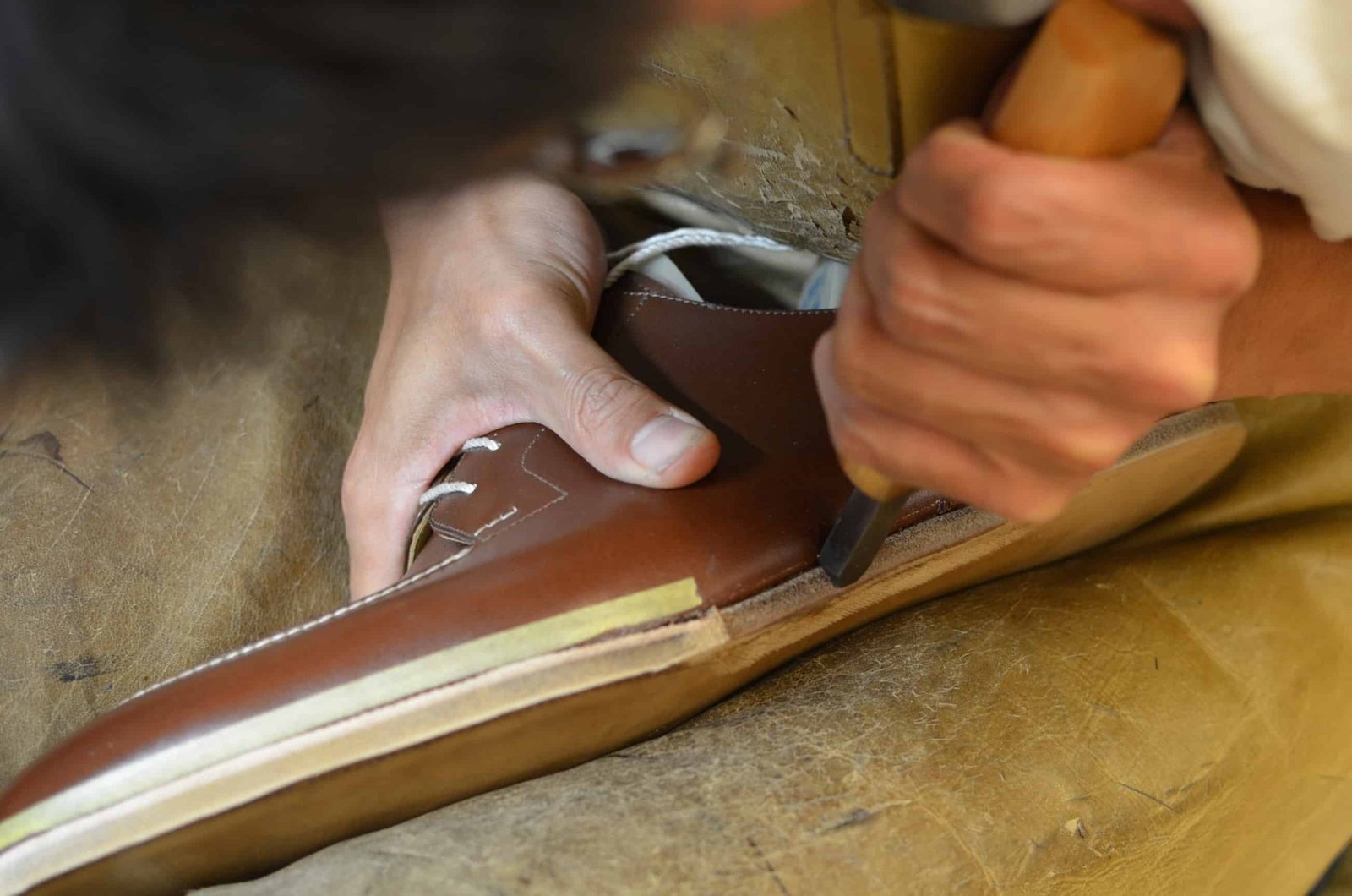 Here the blind welt has been finished and an edge iron is used to even out and shape the edge.