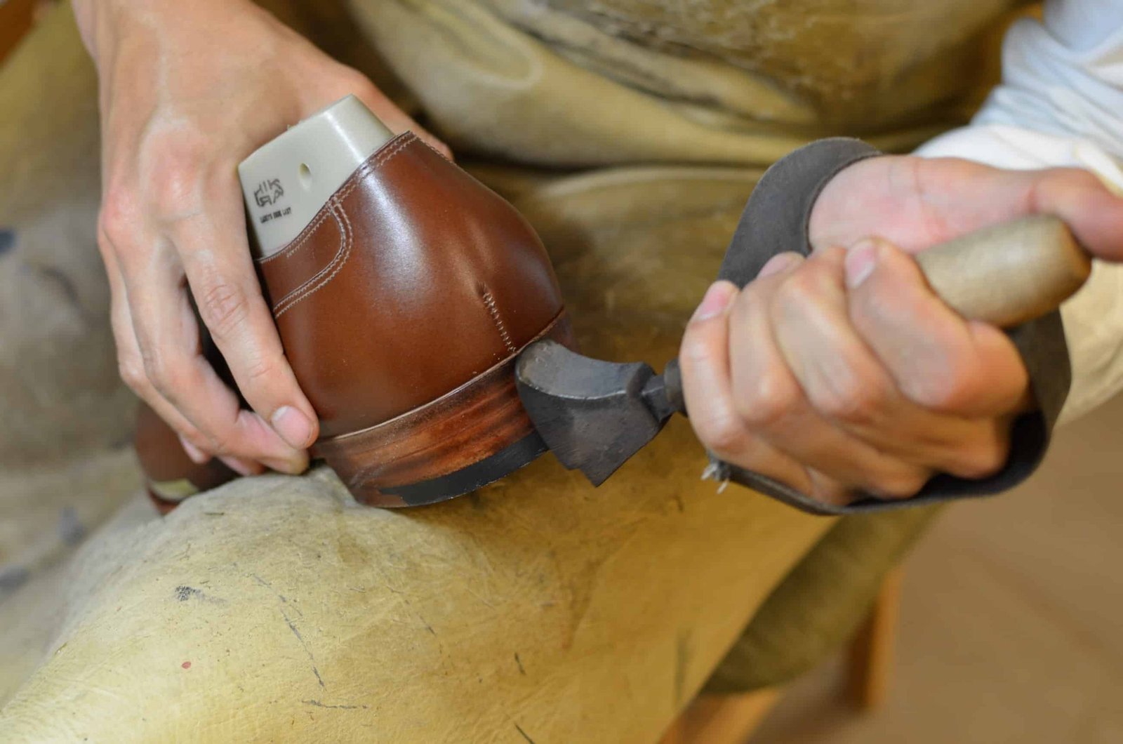 The sole and heel edge has been colored and polished, and now a hot iron burn in the color in the leather.